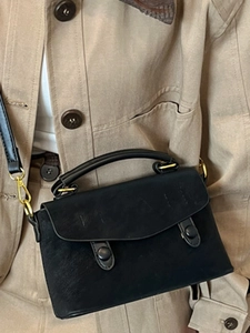 Minimalist vintage black leather crossbody handbag with gold hardware and top handle