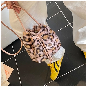 Detail of pink leopard faux fur bucket bag with a cute bow and drawstring closure