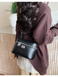 Detail showing smooth black PU leather box bag with silver hardware and top handle