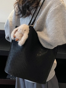 Classic black woven leather tote bag for women with cute plush bunny charm detail
