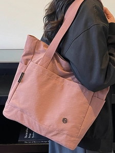 Minimalist dusty pink large tote bag with wide shoulder strap for casual daily use