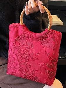 Chic red jacquard tote bag with floral patterns and natural bamboo handles for women