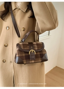 Detail of retro plaid wool and leather stitching shoulder bag with gold buckle