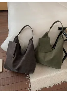 Detail of suede Hobo tote bags in dark coffee and olive green with matching pouches