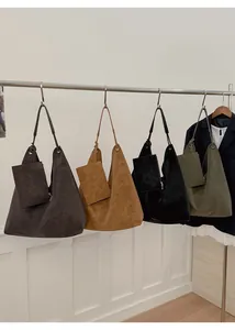 Multiple colors of large suede tote bags displayed with matching small zipper pouches