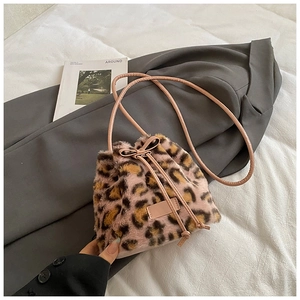 Detail of pink leopard faux fur bucket bag with drawstring closure and bow accent