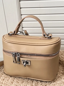 Minimalist beige faux leather box handbag with dual zippers and a metallic turn-lock
