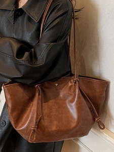 Retro caramel brown oversized tote bag with drawstring details and high-end texture