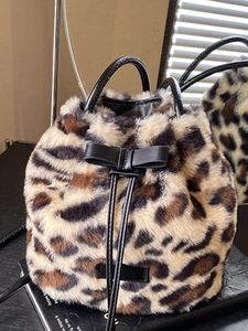 Stylish leopard print plush bucket bag with leather handle and drawstring closure