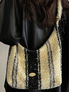 Winter faux shearling tote bag with black and white vertical stripes and handmade metal tag
