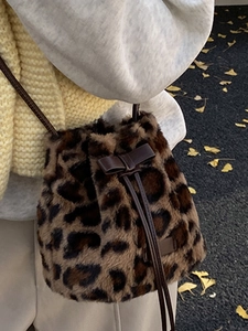 Faux fur leopard print bucket bag with drawstring and bow detail for winter fashion