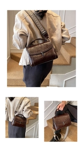 Detail of vintage dark brown crossbody bag with wide geometric strap and metallic clasp