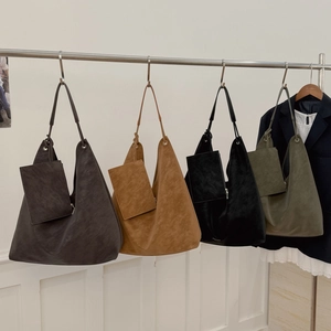 Detail view of large Hobo shoulder bags in four colors with matching mini zip pouches