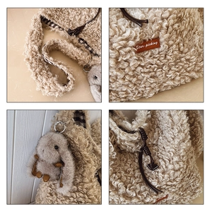 Detail view of beige sherpa tote bag with rabbit charm and leather drawstring closure