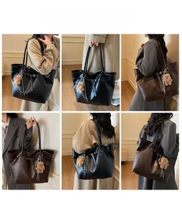 Detail view of large capacity tote bag in black and coffee with bear charm