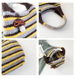 Detail showing knit texture, brown mushroom charm, and interior of striped tote bag