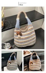 Detail of blue striped crochet hobo bag with a cute 3D mushroom charm attachment