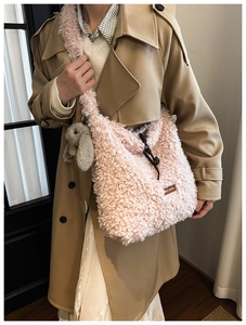 Close-up of pink fluffy plush tote bag featuring a leather star-picking label and rabbit charm