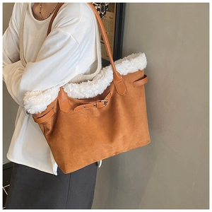 Detail of retro brown suede tote bag with white plush trim and leather handles