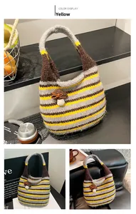 Detail of yellow striped knit hobo bag featuring a cute 3D mushroom charm and bow accent