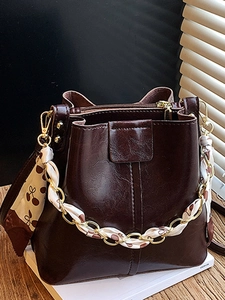Minimalist large bucket bag in dark brown oil-wax leather with cherry silk chain strap