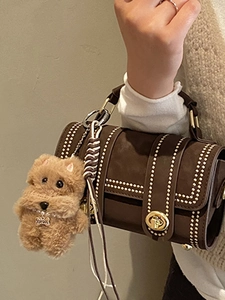 Vintage dark brown suede Boston cylinder bag with golden studs and a plush puppy charm