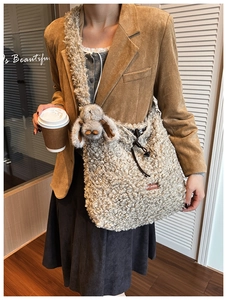 Detail of plush fleece shoulder bag with drawstring closure and cute rabbit ears