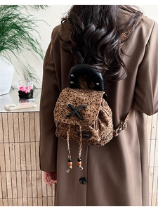 Detail of trendy leopard print mini backpack with rivet handle and drawstring closure