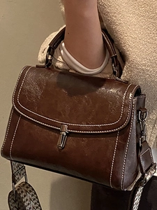 Deep brown retro crossbody handbag with white stitching and textured woven strap