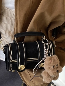 Retro black Boston cylinder bag with gold studs and plush dog charm for women