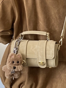 Vintage beige Boston cylinder bag with gold lock and plush dog charm for women
