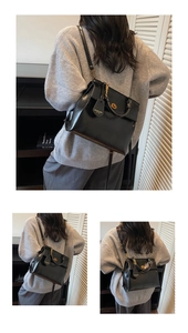 Detail of vintage black leather backpack with gold buckles and adjustable shoulder straps