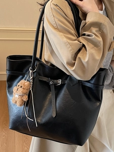 Chic black high-capacity tote bag with brown bear charm for daily office commute