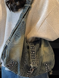 Vintage washed denim tote bag with silver studs and Y2K aesthetic shoulder strap