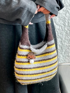 Striped knit mushroom tote bag with decorative charm and crochet pattern handle