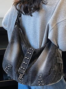 Washed denim hobo tote bag with silver studs and crescent moon shape design