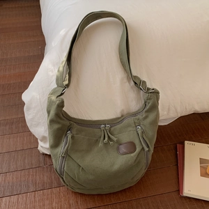 Detailed macro shot of army green canvas fabric texture and zipper pocket on tote bag