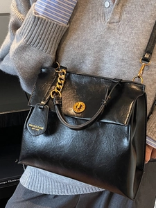 Vintage black leather backpack with gold clasp and chain for women school or travel use