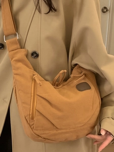 Winter canvas tote bag in mustard yellow shown with a professional trench coat