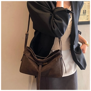 Detail of vintage dark brown soft leather tote bag with strap and metal buckle