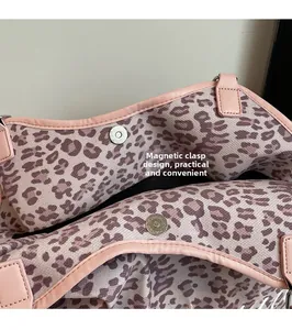 Detail view of pink leopard print canvas tote bag featuring magnetic snap closure
