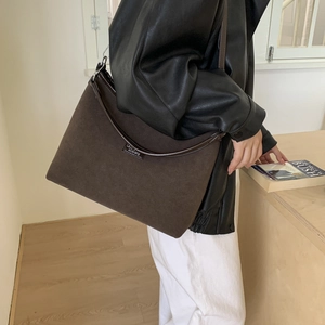 Close-up of minimalist retro tote bag in brown matte leather with elegant stitching detail