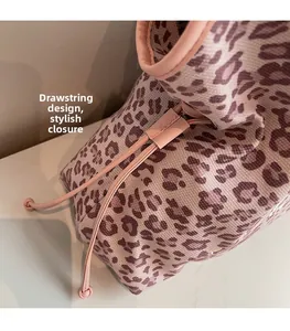 Detail view of pink leopard print fabric with drawstring closure and leather trim