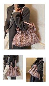 Close-up of pink leopard print tote bag with gold lettering and drawstring detail
