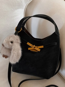 Borsa a sella chic in pelle scamosciata nera con chiusura dorata e ciondolo di peluche