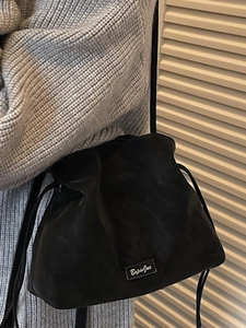 Chic black drawstring bucket bag in matte leather texture for winter casual shoulder wear