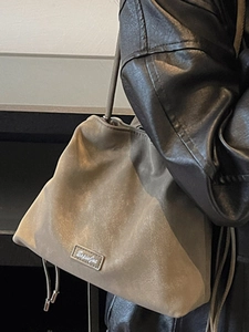Modern taupe bucket bag with drawstring detail and adjustable shoulder strap for women