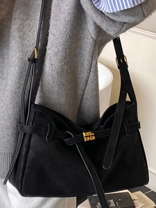 Large black suede hobo bag with gold buckle for women, shown on shoulder for daily commute