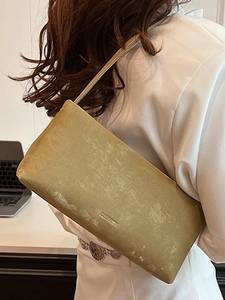 Minimalist yellow velvet shoulder bag with embossed logo and slim strap for women