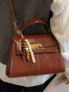 Brown shiny leather trapezoid handbag with vintage beads and gold clasp hardware